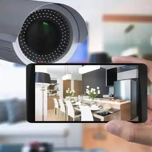 An expert's hand pointing to the best home security cameras displayed on a screen